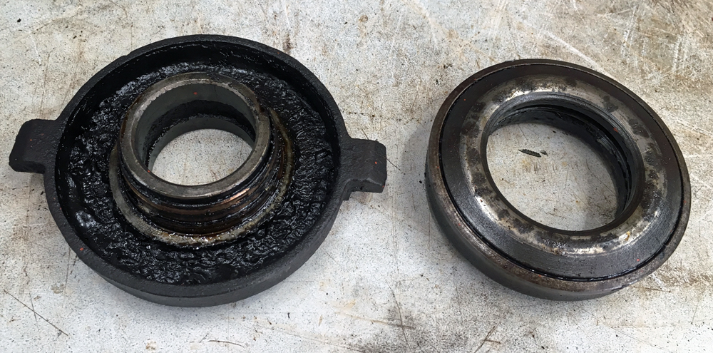 Throwout bearing carrier (left) has a bunch of gunk in it.  (Photo © Russ Chastain)