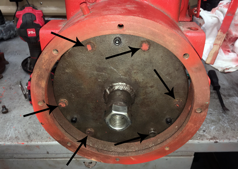 Specialized puller, installed on a clutch flywheel. Arrows indicate bolts holding puller to flywheel. I use 6 of the 8 bolts from the clutch pedal housing. (Photo © Russ Chastain)